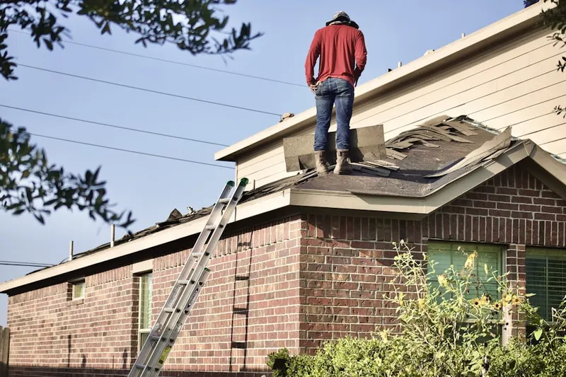 Professional roofer working on a residential roof in Lockport